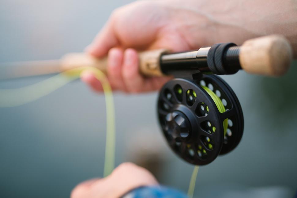 Free Image of Close-up of fisherman s hands using fly rod 
