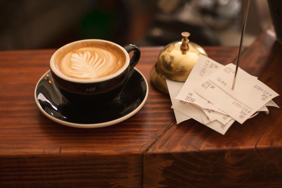 Free Image of Latte art on coffee in a black cup 