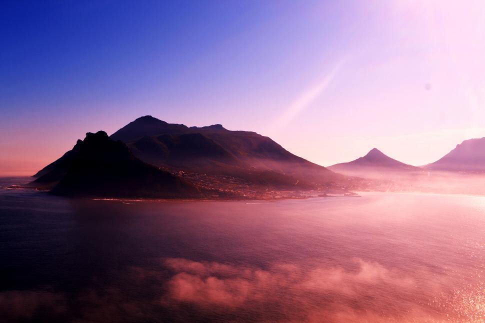 Free Image of Sunrise hue over a peaceful coastal town 