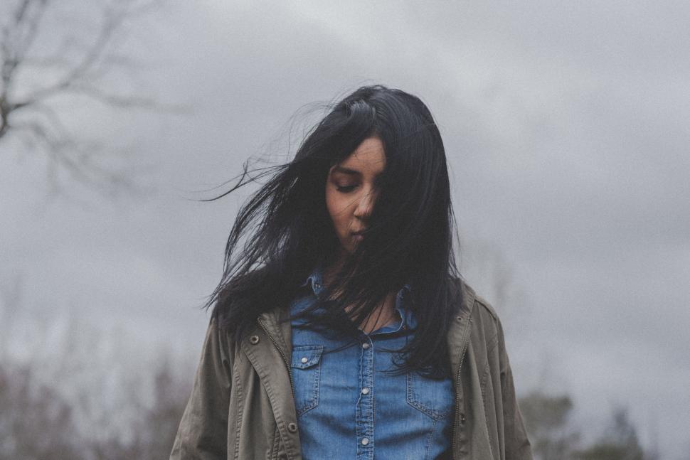 Free Image of Contemplative woman with windswept hair 