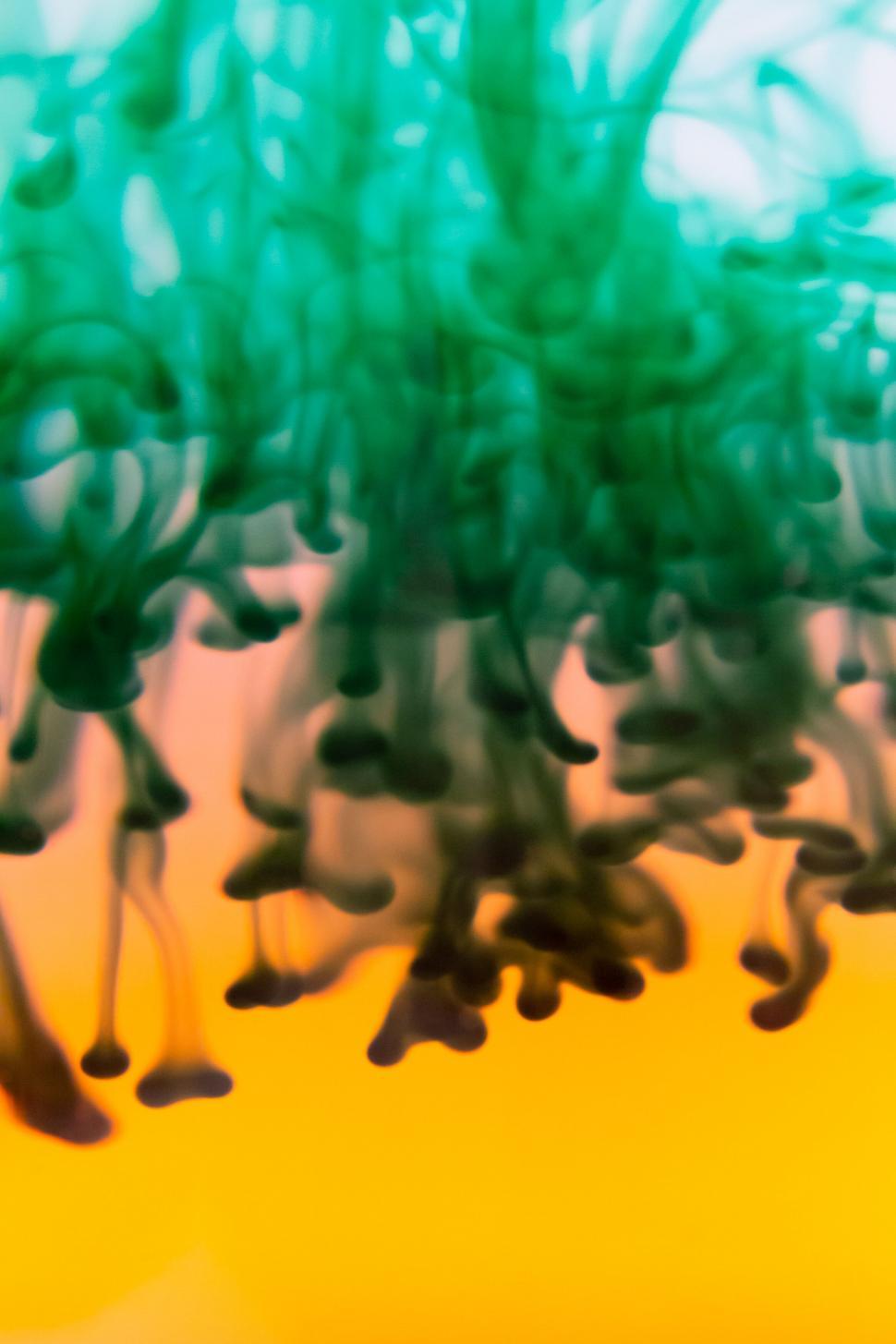 Free Image of Vibrant Green and Blue Ink Clouds in Water 