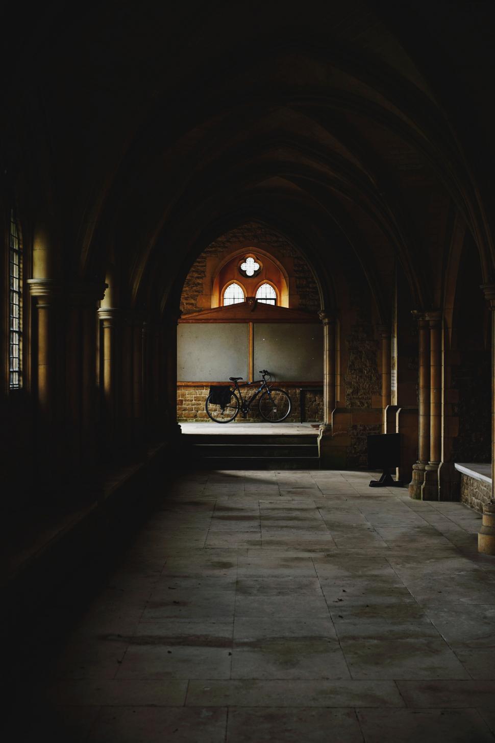 Free Image of Ancient hallway with lone bicycle 