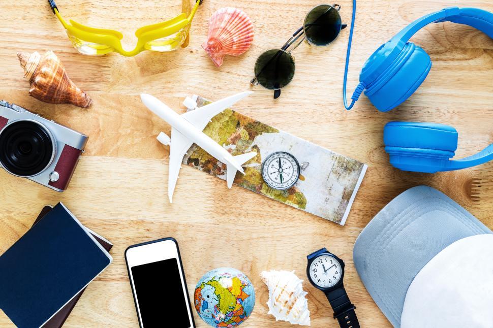 Free Image of Travel essentials laid out on wooden background 