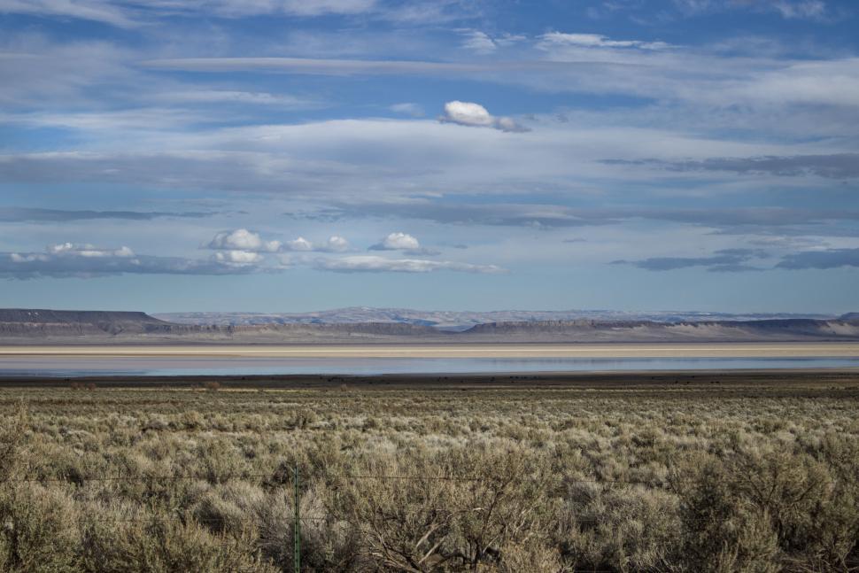 Free Image of Vast desert landscape with blue skies and clouds 