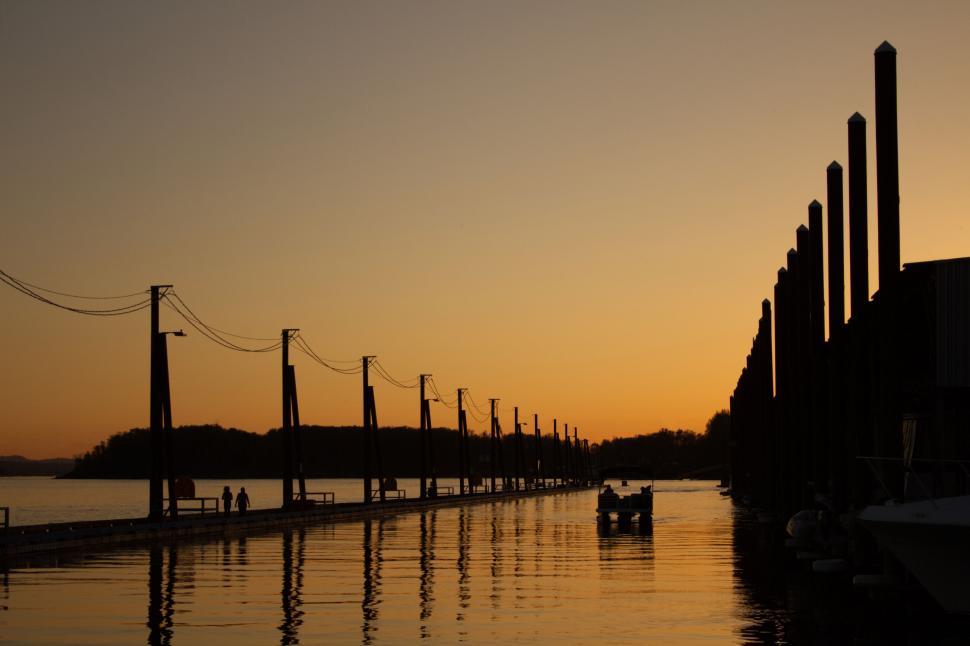 Free Image of Serene sunset at a tranquil waterfront pier 