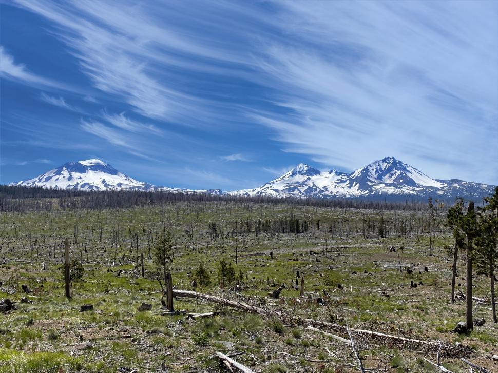 Free Image of Majestic mountains under a blue sky with clouds 