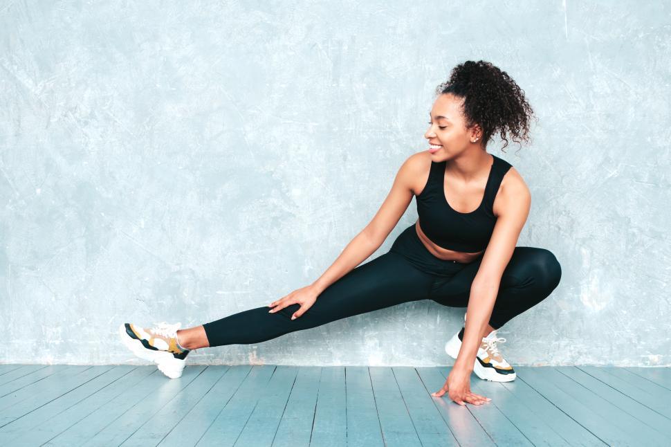 Free Image of A woman stretching her leg 