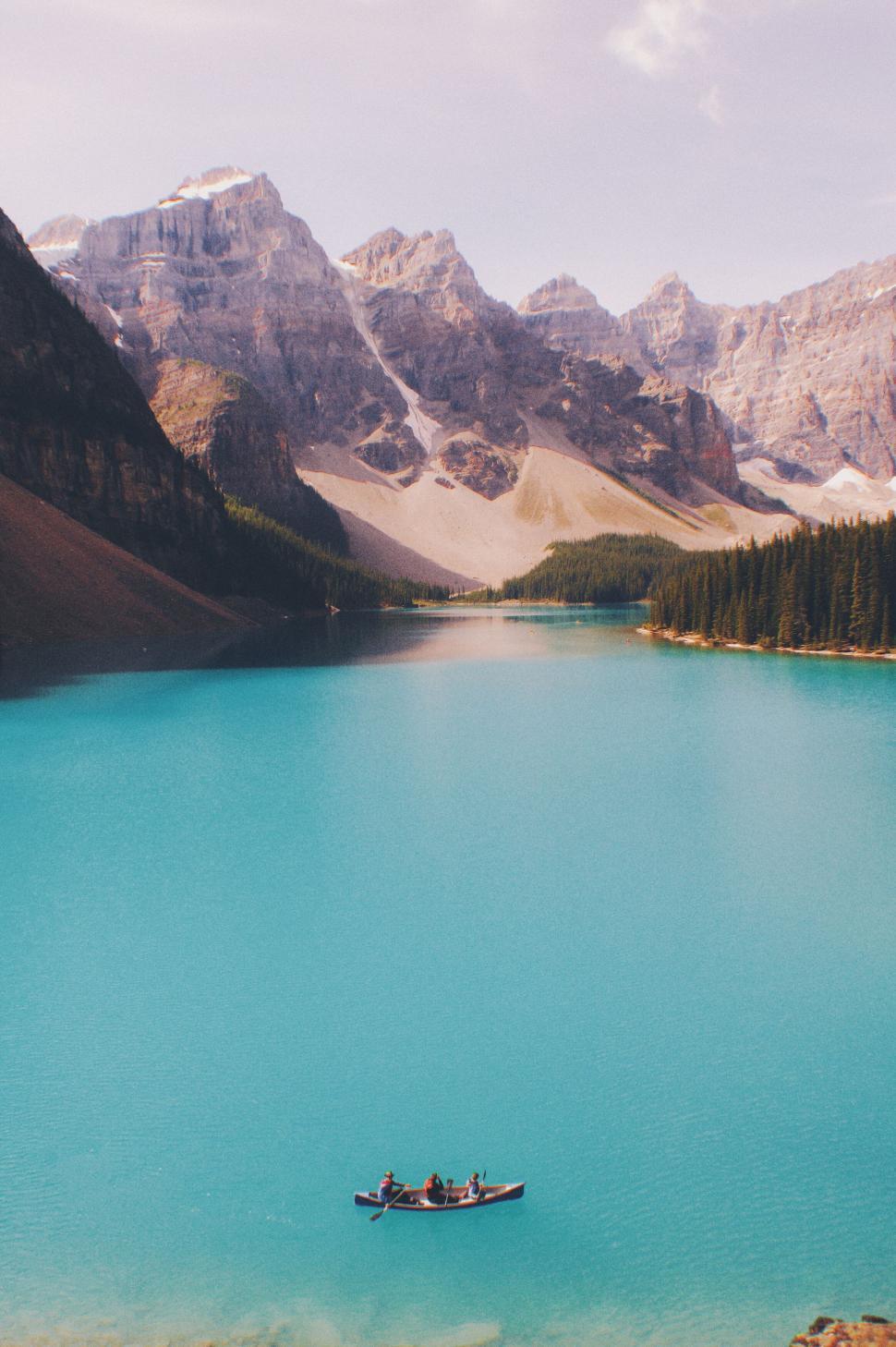 Free Image of Canoeing on pristine mountain lake with family 