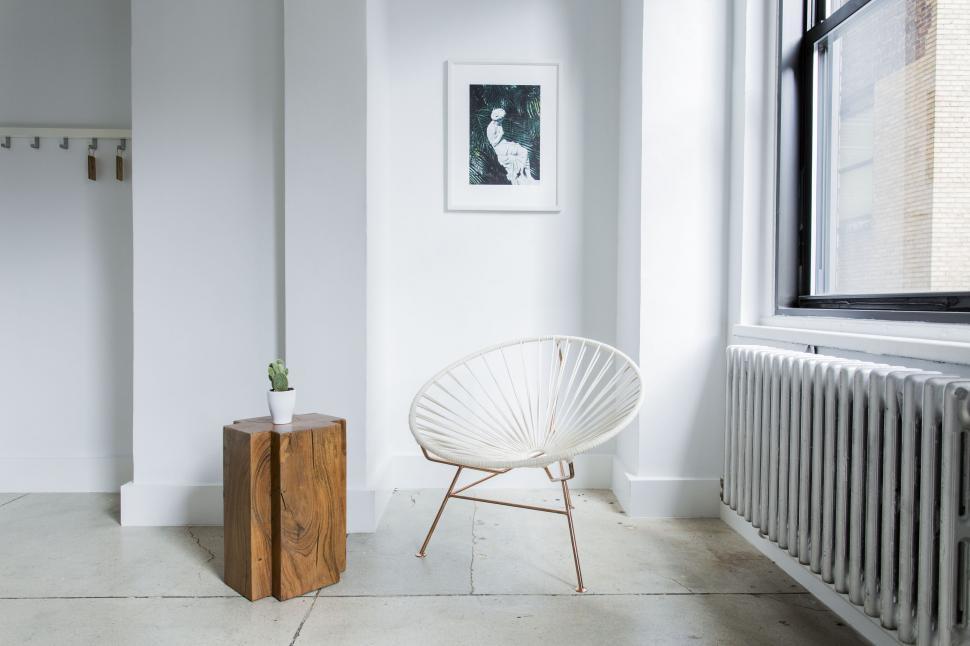 Free Image of Clean living space with framed abstract portrait 
