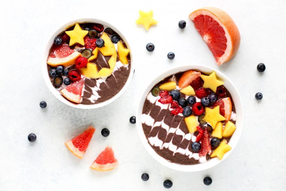 Free Image of Colorful fruit bowls on white backdrop 