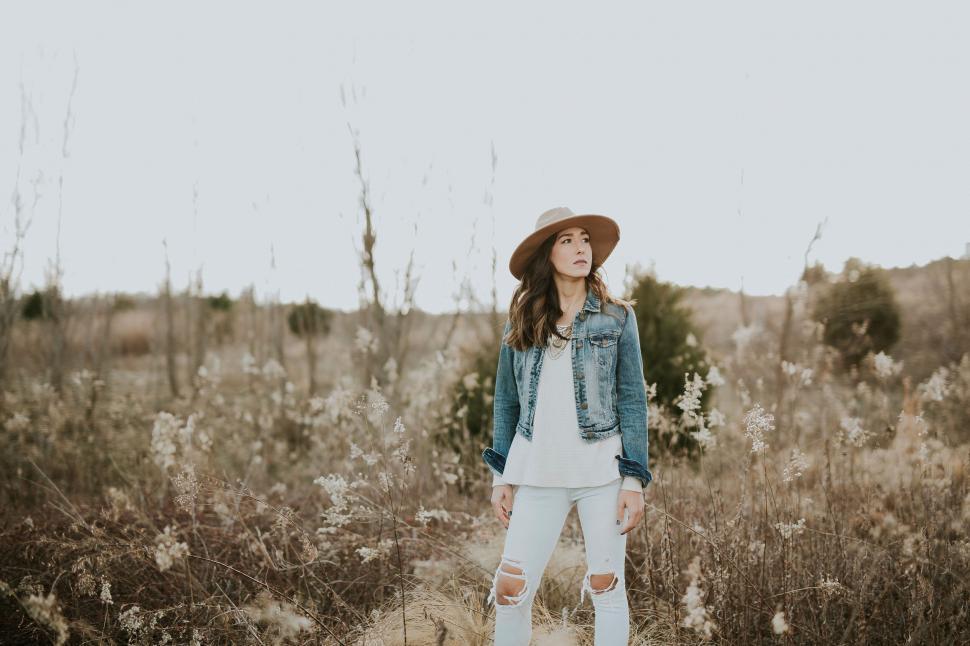 Free Image of Woman with hat standing in a field 