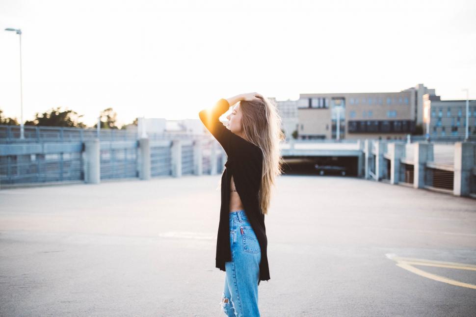 Free Image of Backlit figure against urban sunset backdrop 