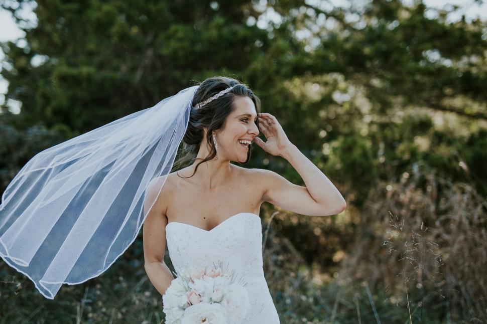 Free Image of Joyful bride laughing in nature 