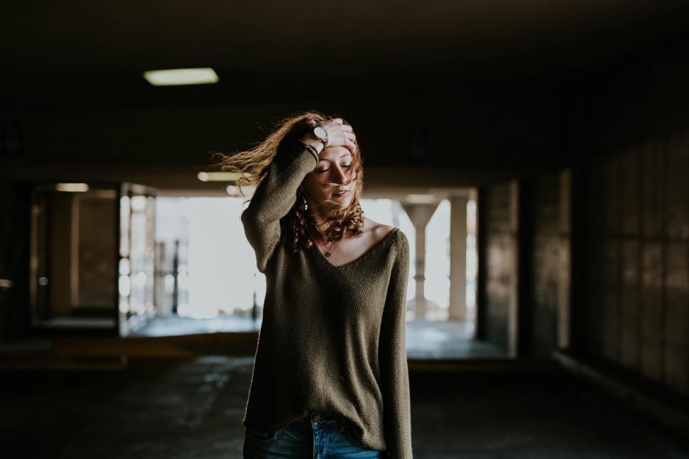 Free Image of Woman posing in dimly lit parking garage 