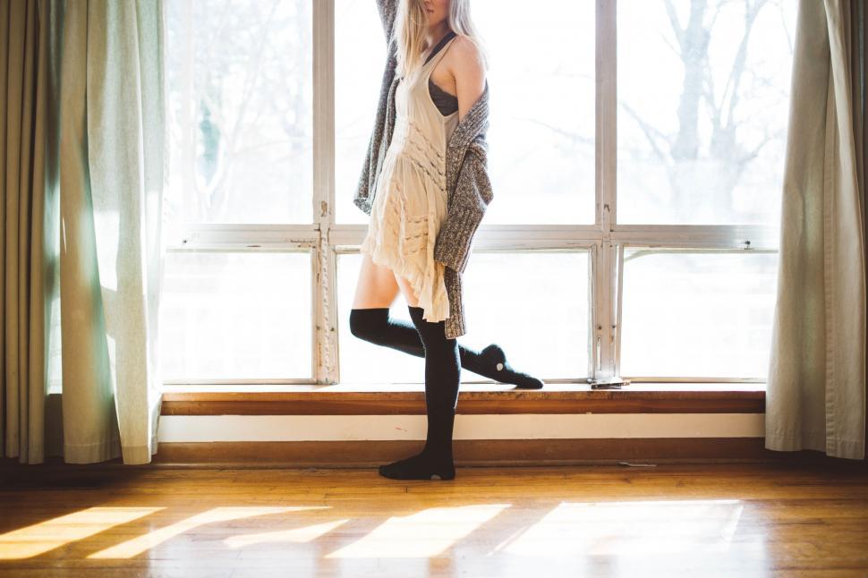 Free Image of Silhouette of a woman dancing by the window 