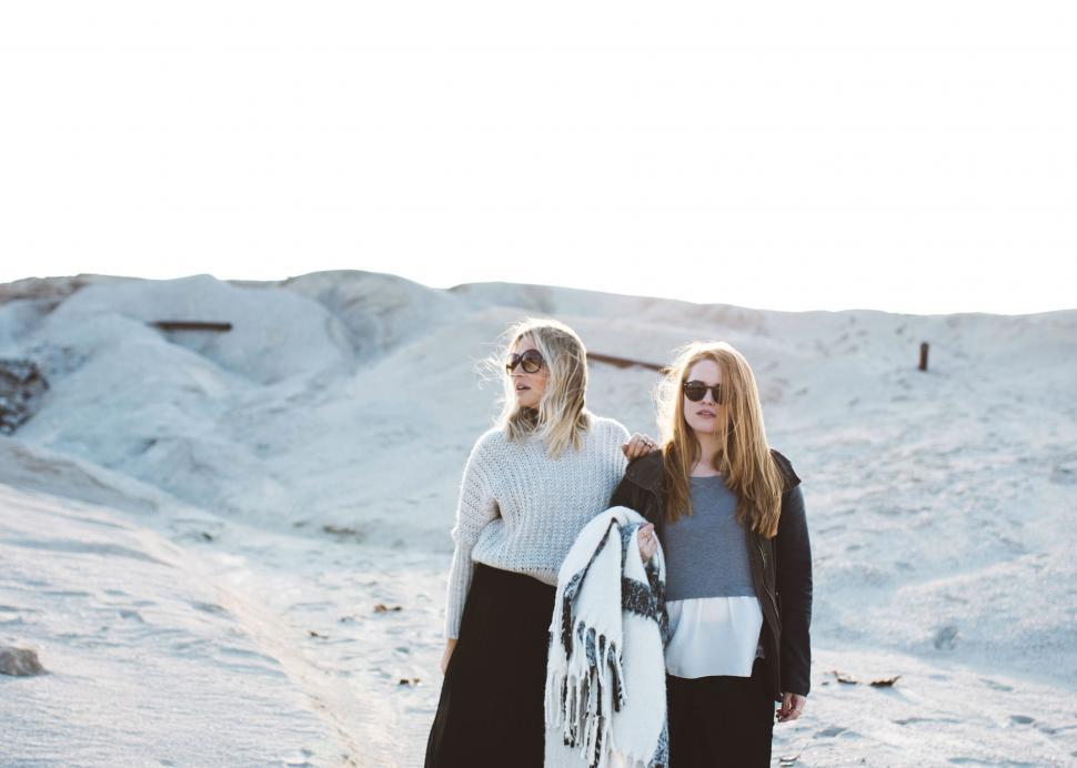 Free Image of Two women walking on sandy terrain 