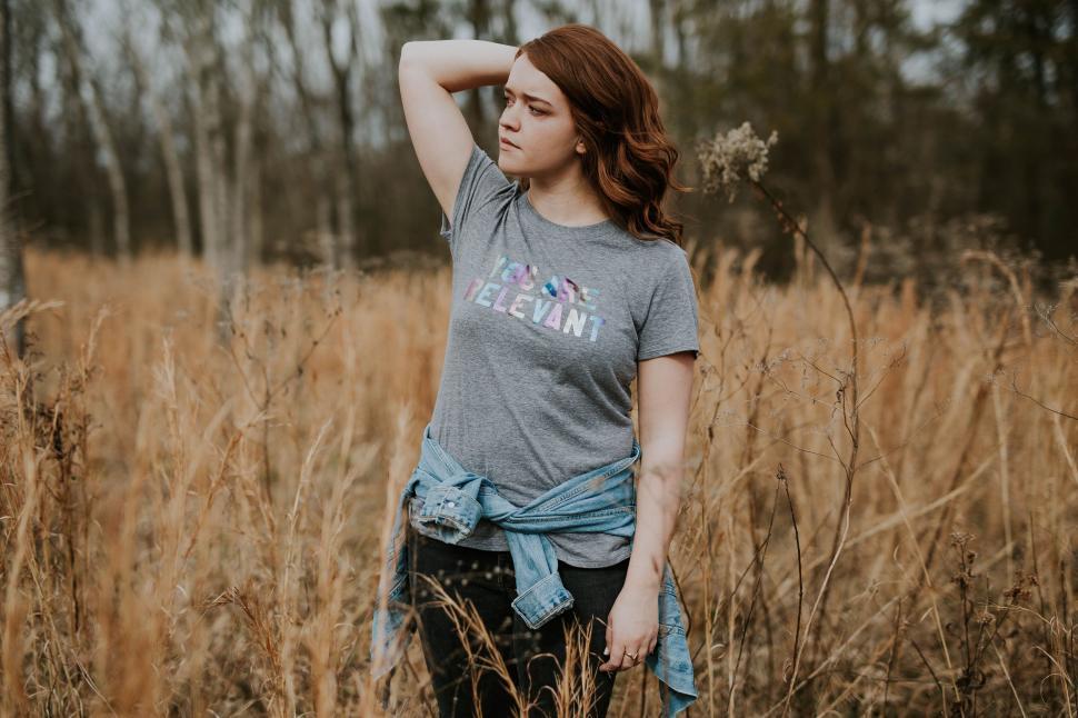 Free Image of Woman standing thoughtfully in autumn field 