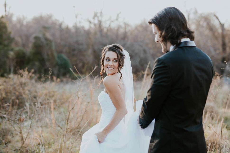 Free Image of Bride smiling over shoulder at groom 