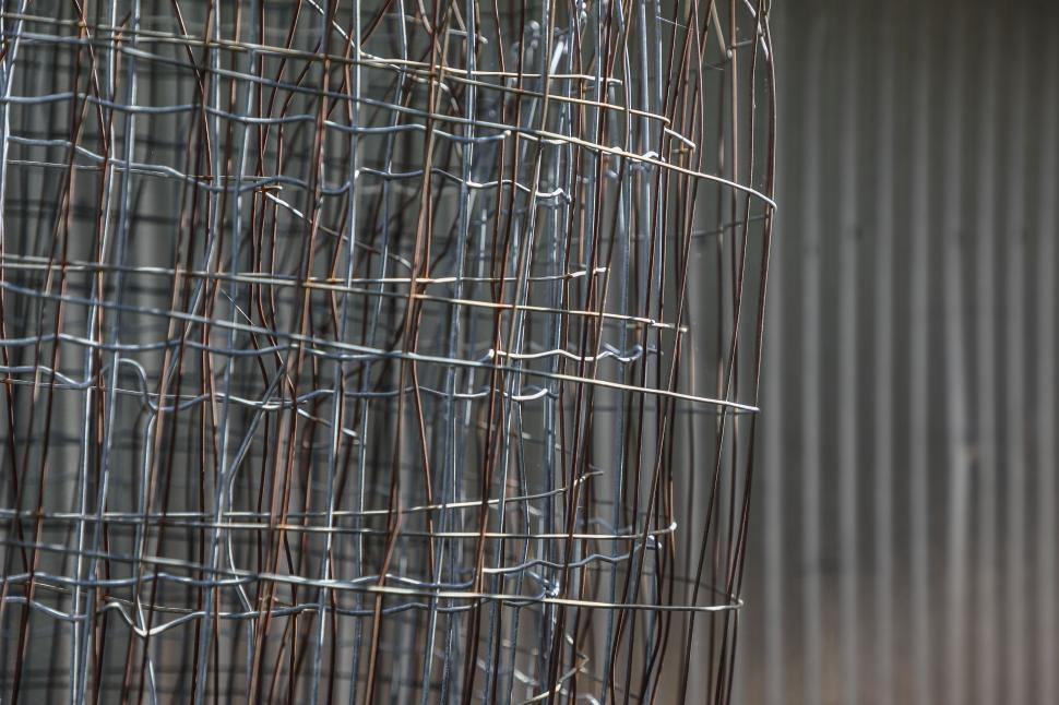 Free Image of Tangled wires on metal fencing close-up 