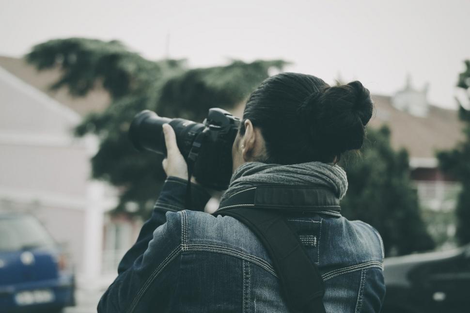 Free Image of Photographer in action with DSLR camera 