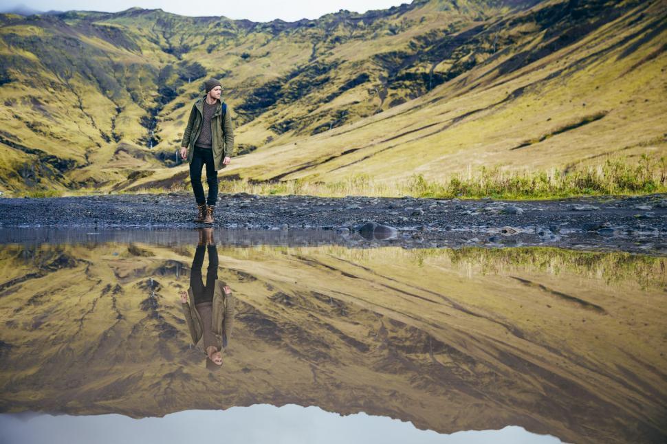 Free Image of Person walking alone in vast mountain landscape 