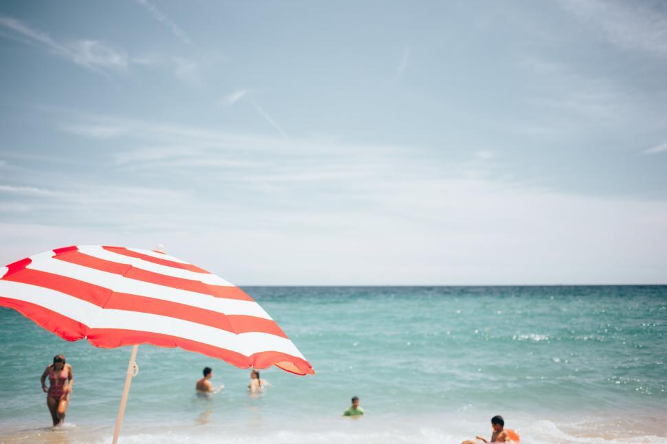 Free Image of Beachscape with red and white umbrella 