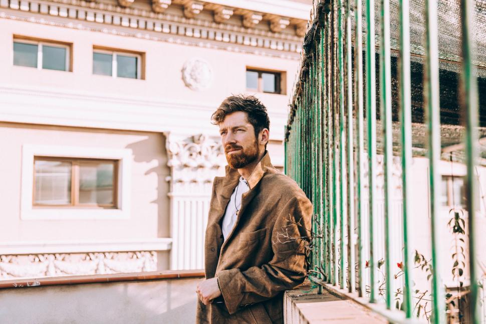 Free Image of Fashionable man with vintage backdrop 