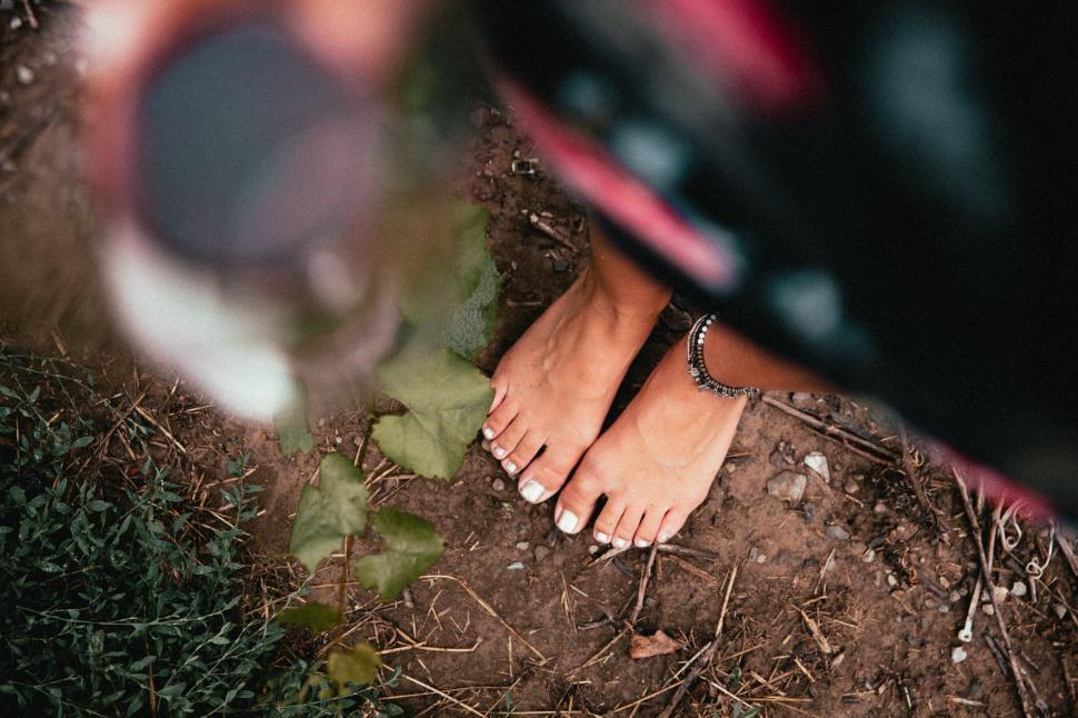 Free Image of Barefoot woman standing in nature 