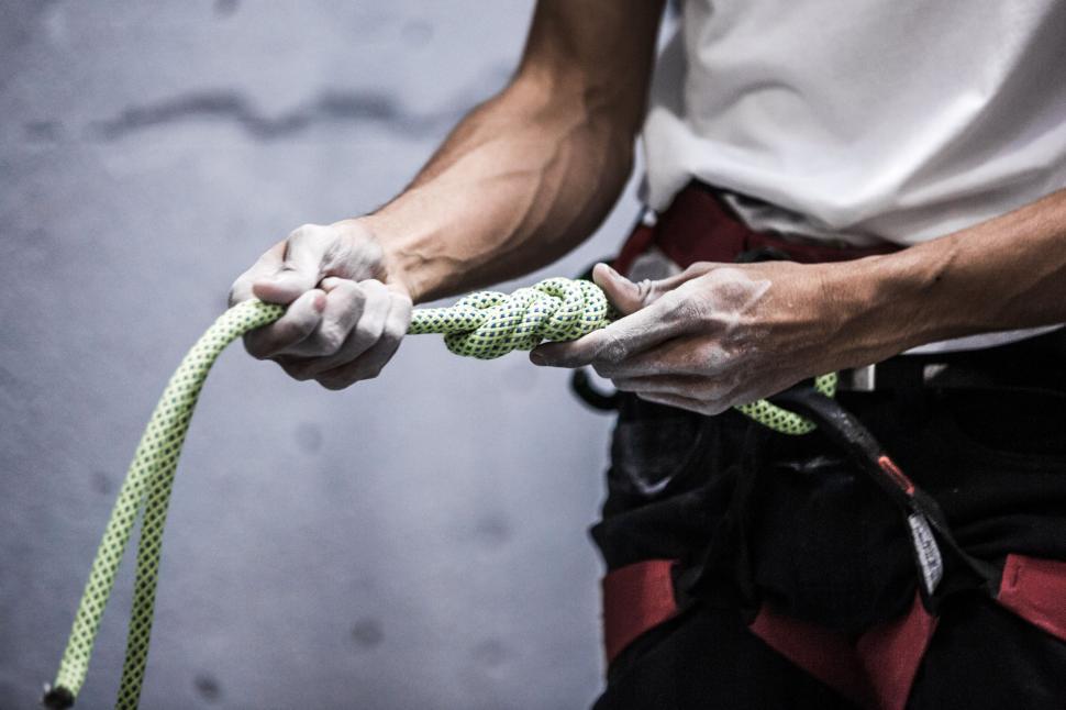Free Image of Climber gripping a rope tightly with focus 