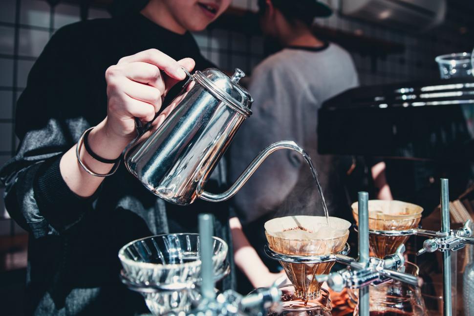 Free Image of Barista pouring hot water over coffee grounds 
