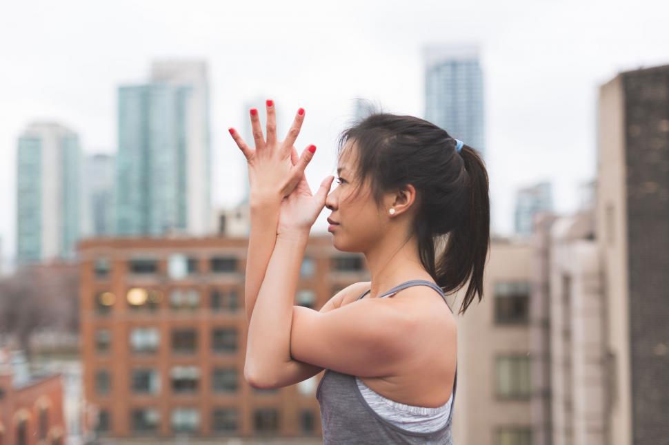 Free Image of Woman showing peace sign in cityscape 