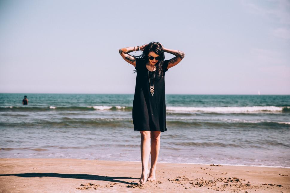 Free Image of Woman enjoying freedom at sandy beach 