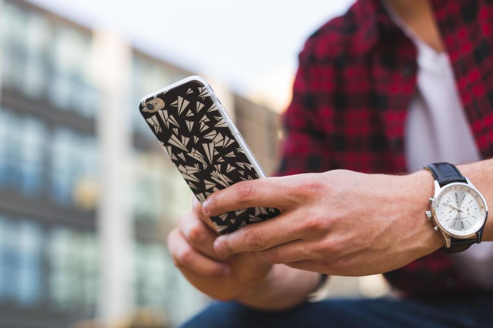 Free Image of Man using smartphone in urban setting 