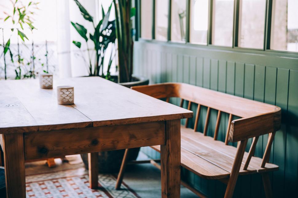 Free Image of Minimalist wooden table in serene corner 