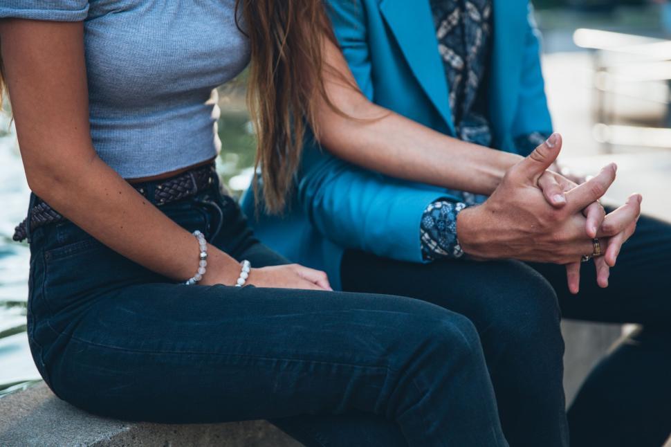 Free Image of Couple holding hands in candid moment 