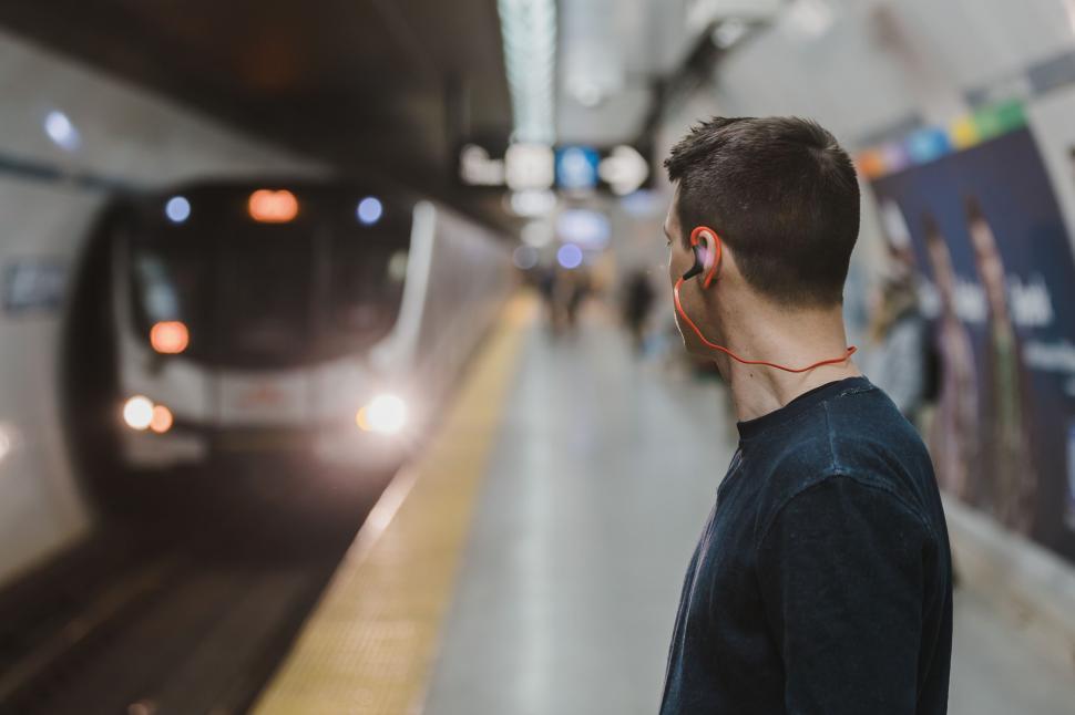 Free Image of Man waiting for train at subway platform 
