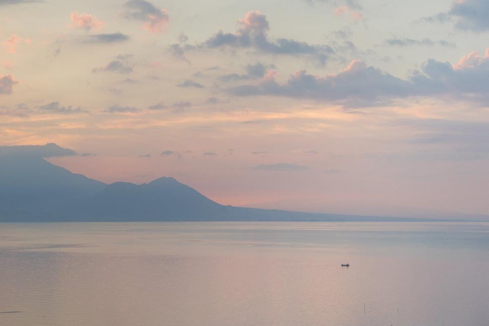 Free Image of Serene lake with a solitary boat 