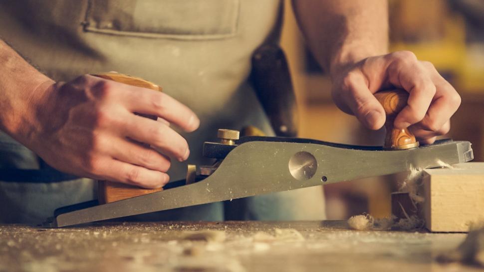 Free Image of Craftsman planing wood in workshop 