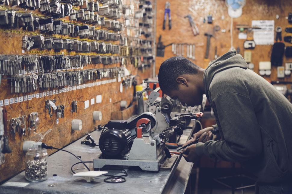 Free Image of Craftsman working with key cutting machine 
