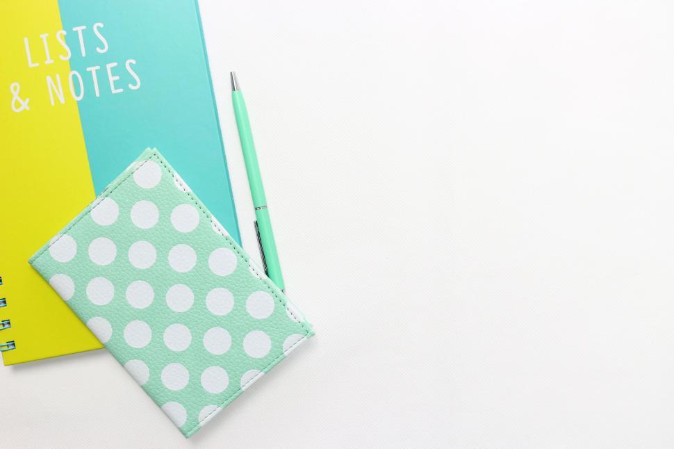Free Image of Notebook with Lists &amp Notes on yellow surface 