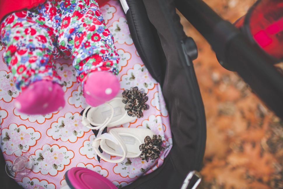 Free Image of Child in stroller with colorful clothes 