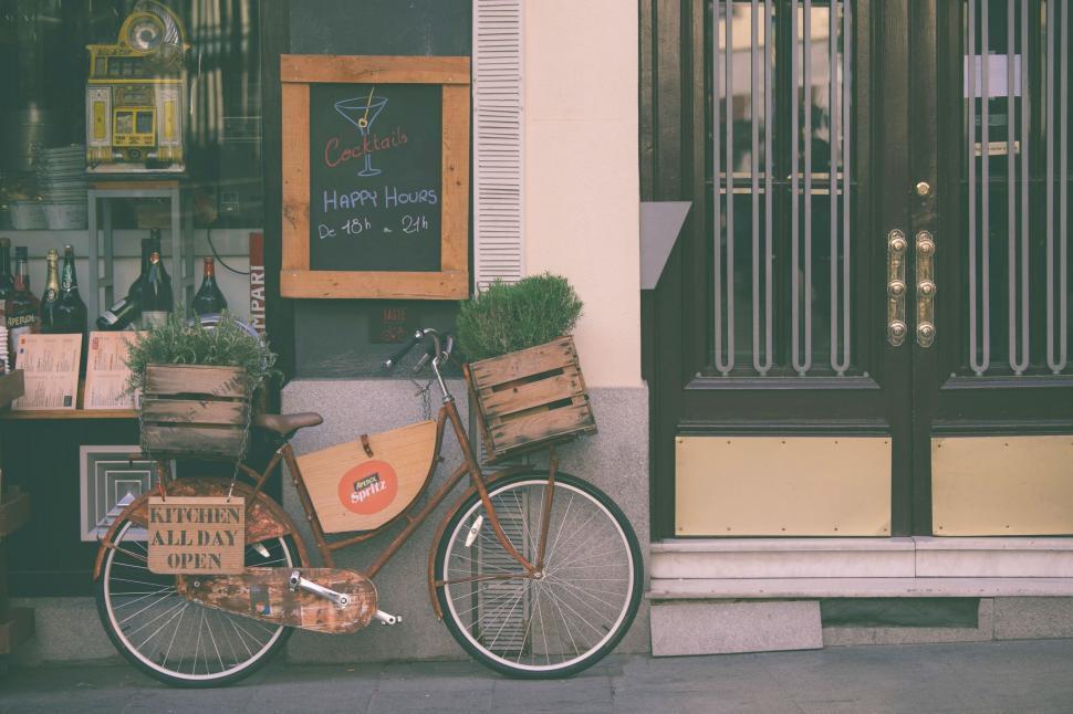 Free Image of Bicycle outside a quaint cafe entrance 