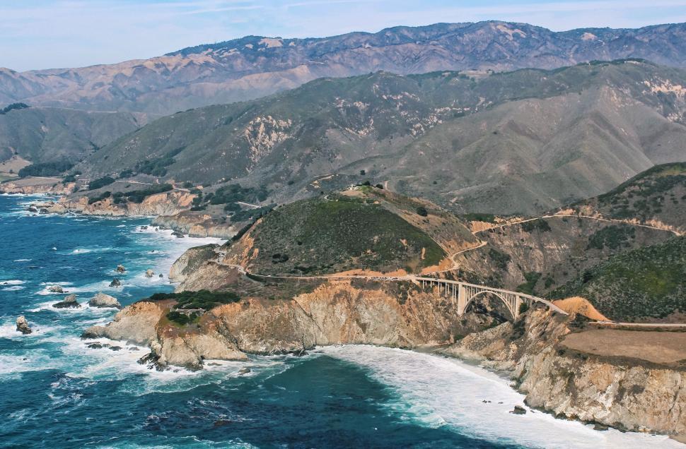 Free Image of Rugged cliffs along a coastal road 