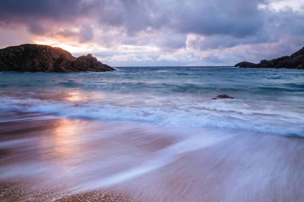 Free Image of Sunset paints the sky over a turbulent sea 