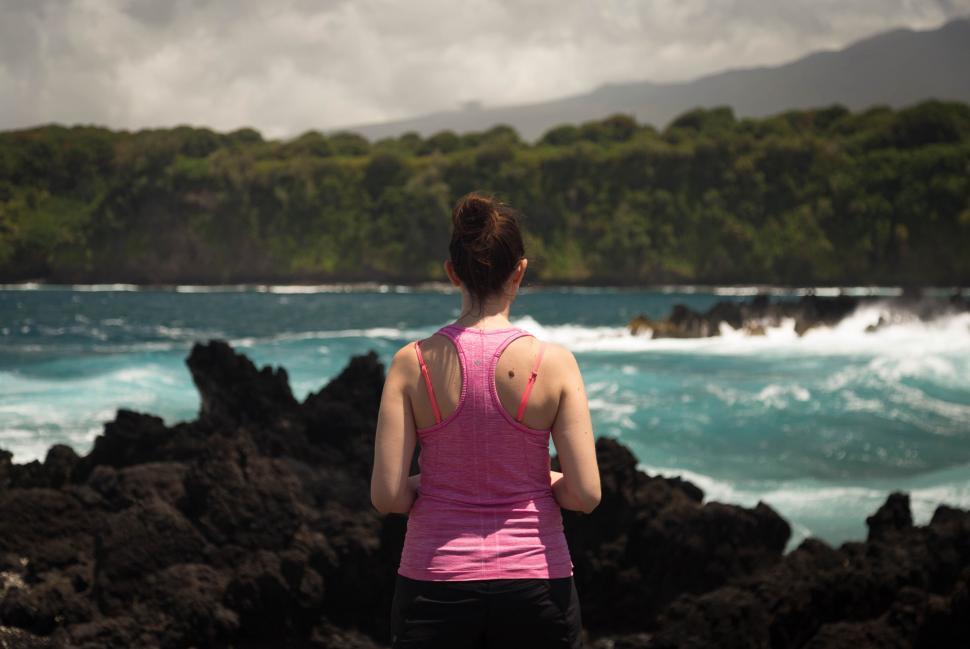 Free Image of Woman overlooking turbulent ocean and cliffs 