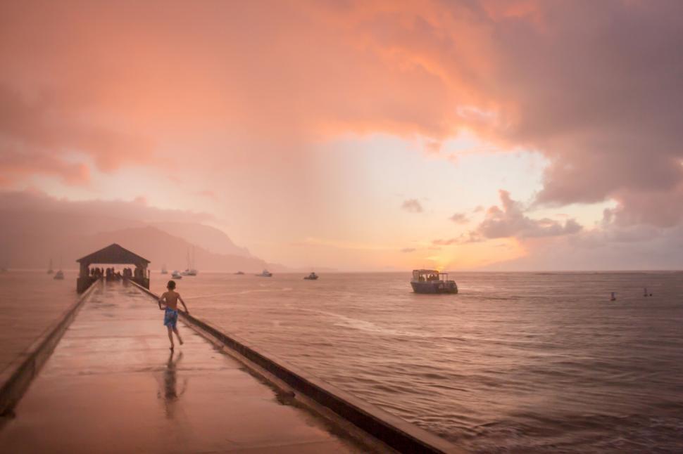 Free Image of Tranquil pier at sunset with calm ocean 