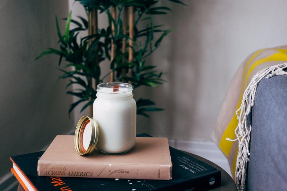 Free Image of Candle on books cozy home setting 