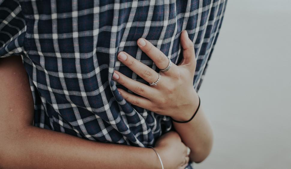 Free Image of Close-up of couple embracing in plaid clothing 