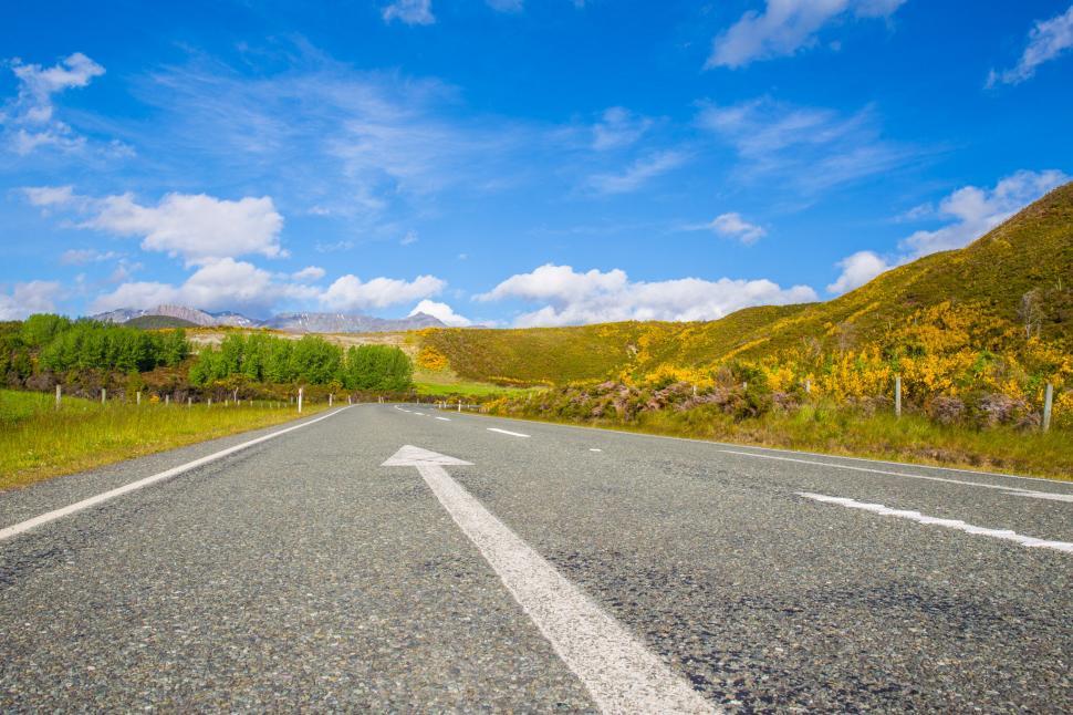 Free Image of Open road leading towards mountain range under sky 
