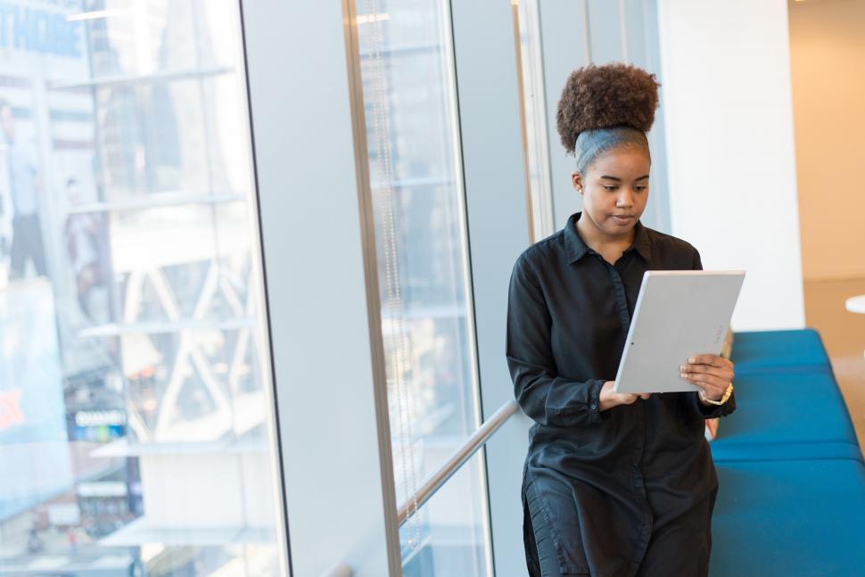 Free Image of Young woman on staircase with tablet 